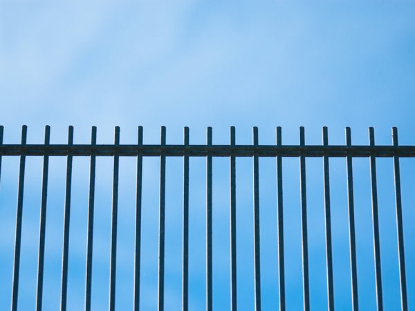 Metal Fence Panels Against a Blue Sky