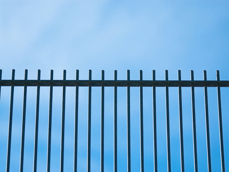 Metal Fence Panels Against a Blue Sky