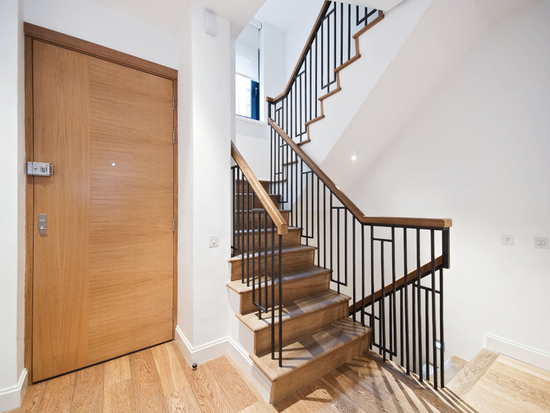 Simple metal stair spindles on a minimal wooden staircase